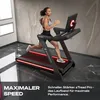 A woman is running on a treadmill in a modern room. Produktbild-Vorschau