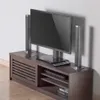 A TV stand with a TV, speakers, and media devices on it, placed against a white wall. Náhľad obrázku produktu