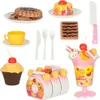 A collection of toy food items, including cakes, cookies, a cup, and cutlery, arranged on a white background. Podgląd zdjęcia produktu