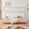 A child's bed with a house frame, decorated with fairy lights, and featuring stuffed animals and bedding. Náhľad obrázku produktu