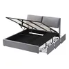 A grey upholstered bed frame with the mattress support lifted to reveal storage space underneath. Three drawers are visible on the side. Produktbild-Vorschau