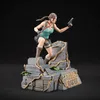 A Lara Croft statue from Tomb Raider, posed dynamically on a ruined stone base. Anteprima dell’immagine prodotto