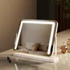 A makeup mirror with integrated LED lighting is displayed on a vanity table.