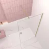 A modern bathroom corner with a glass shower enclosure and pink tiled walls. Produktbild-Vorschau