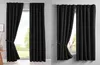 Two images of black curtains hanging on a window, one with the curtains tied back and the other with them partially closed. Produktbild-Vorschau