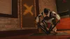 A person in tactical gear is crouching and setting up a device on the floor in a room. Produktbild-Vorschau