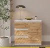 A modern sideboard with drawers and a door, placed next to a potted plant and a table lamp. Produktbild-Vorschau