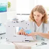 A young woman is sewing on a white sewing machine in a bright room. Produktbild-Vorschau