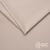 A folded piece of beige fabric, likely upholstery or bedding, with a logo in the bottom right corner. Náhled obrázku produktu