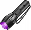 A black tactical LED flashlight with a purple light emitting from the front, shown at an angle on a white background. Produktbild-Vorschau