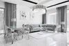 A modern living and dining room with a sectional sofa, dining table, and chandelier. Produktbild-Vorschau