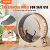 A cat is running on a wooden exercise wheel in a room. Náhľad obrázku produktu