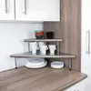 A corner shelf unit with cups, bowls, and plates on a kitchen counter. Produktbild-Vorschau