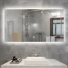 A modern bathroom with a sink and a large illuminated mirror reflecting a shower. Produktbild-Vorschau