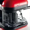 Close-up view of a red and black espresso machine. Produktbild-Vorschau
