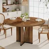 A round wooden dining table with chairs in a dining room setting. Voir les images du produit