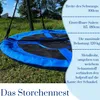 A close-up of a blue and black nest swing on a grassy lawn. Produktbild-Vorschau