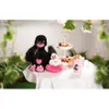 Two plush swans and a tiered dessert stand with fruit and pastries are arranged on a table covered with a white tablecloth. Produktbild-Vorschau
