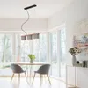 A dining area with a table, chairs, and a pendant light. Produktbild-Vorschau