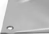 A close-up view of a gray PVC tarp with a metal grommet. Voir les images du produit