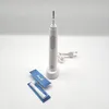 A white electric toothbrush and its accessories are displayed on a white background. Produktbild-Vorschau