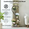 A multi-tiered plant stand with flowers and decorative items displayed in a room with sheer curtains and a sofa in the background. Anteprima dell’immagine prodotto