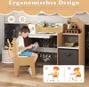 A young boy is sitting at a child's desk and chair, reading a book. The desk has shelves and a drawer. The chair has an ergonomic design highlighted with graphics. Produktbild-Vorschau