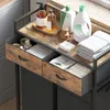 A close-up view of a laundry cart with drawers and shelves, displaying various cleaning products and folded towels. Voir les images du produit