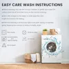 A washing machine with water splashing out, surrounded by laundry baskets and plants, with text providing washing instructions. Produktbild-Vorschau