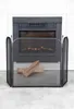A fireplace screen in front of a fireplace with two pieces of wood on it. Produktbild-Vorschau