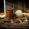 A rustic still life arrangement featuring a ceramic crock, cabbage, and several ceramic weights for fermenting food. Anteprima dell’immagine prodotto