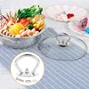 A close-up view of a pot lid knob and its components, with a hot pot in the background. Produktbild-Vorschau