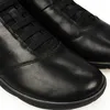 A close-up view of a pair of black leather shoes. Produktbild-Vorschau