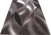 A rectangular rug with a modern abstract design is shown from a diagonal angle on a white background. Produktbild-Vorschau