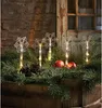 Snowflake LED lights are placed in a wooden box filled with pine branches, pinecones, and apples. Podgląd zdjęcia produktu