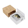 A cat figurine is lying inside a white box next to an open wooden box. Produktbild-Vorschau