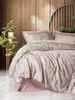 A bedroom scene with a bed made with a floral patterned duvet cover and pillows. Produktbild-Vorschau