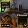 A woman sleeping in bed next to a small black heater on a nightstand. The image includes marketing overlays highlighting the heater's features. Produktbild-Vorschau