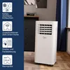 A white portable air conditioner is shown in a room with a dark cabinet and a window with blue curtains. Produktbild-Vorschau
