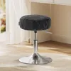 A black adjustable stool with a silver base in a room with light-colored carpet and a window with sheer curtains. Náhled obrázku produktu