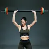 A woman is lifting a barbell. Náhľad obrázku produktu