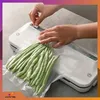A person is using a white vacuum sealer machine to seal a bag of green beans. Podgląd zdjęcia produktu