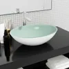 A bathroom sink on a black vanity with a tiled backsplash and a mirror. Podgląd zdjęcia produktu