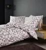 A bed with bedding set in a bedroom setting. Produktbild-Vorschau