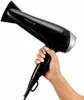 A hand holding a black Remington hairdryer against a white background. Náhled obrázku produktu