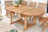 An oval wooden garden table with chairs on a deck. Produktbild-Vorschau