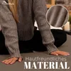 A person wearing a grey sweater is sitting on a grey surface, with a close-up inset of the fabric. Produktbild-Vorschau