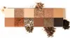 A palette of eyeshadows with various shades of brown, beige, and gold, some with glitter. Produktbild-Vorschau