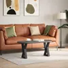 A living room scene with a couch, coffee table, and artwork. Náhled obrázku produktu
