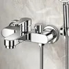A close-up view of a chrome-finished shower faucet mounted on a marble-patterned wall. Produktbild-Vorschau